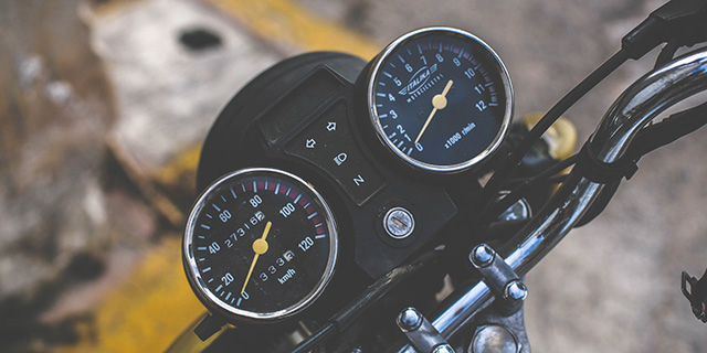 A top-down view of a motorcycle speedometer and tachometer.